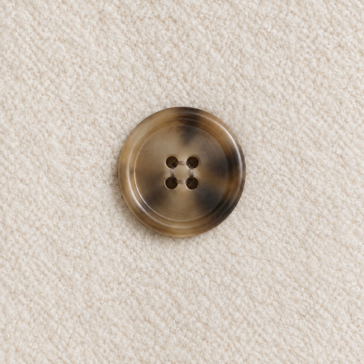 Approved four-hole button detail after restrained background cleanup